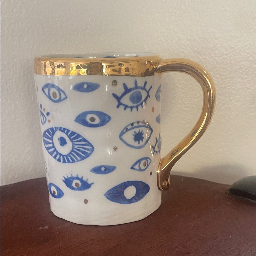 Anthropologie White coffee cup with Blue Eye Design
